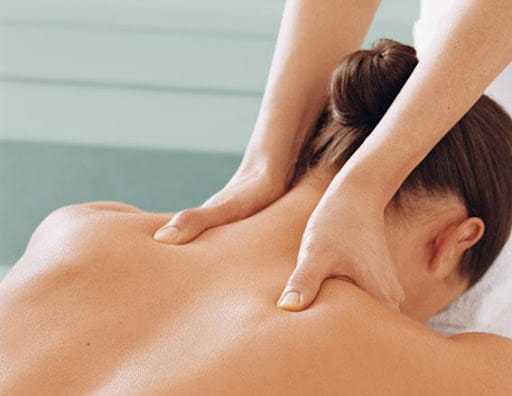Person receiving a back massage, highlighting relaxation.