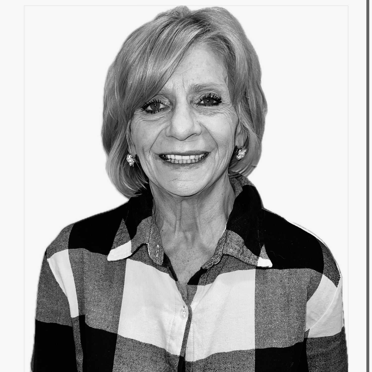 Portrait of Tina, a professional stylist at The Robert Andrew Salon & Spa Collection, showcasing their expertise and style.