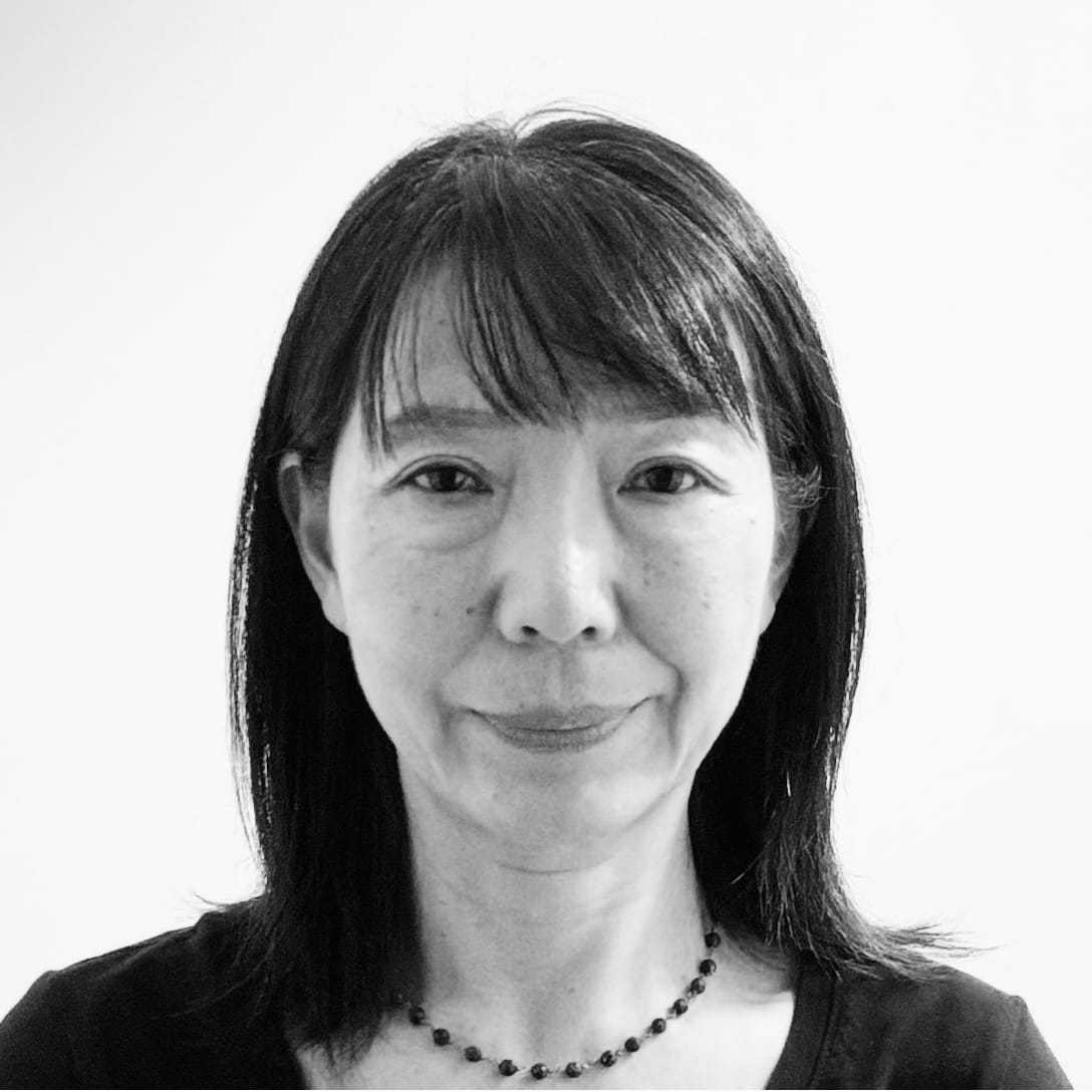 Portrait of Yoko, a professional stylist at The Robert Andrew Salon & Spa Collection, showcasing their expertise and style.