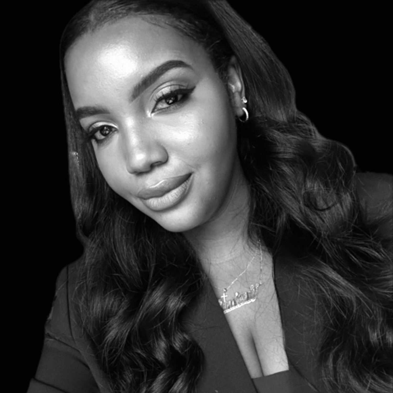 Portrait of Jannique, a professional stylist at The Robert Andrew Salon & Spa Collection, showcasing their expertise and style.