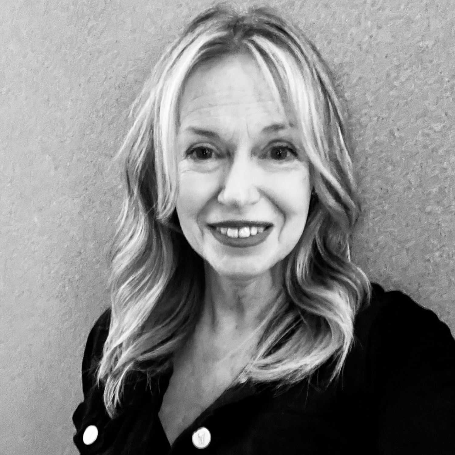 Portrait of Debbie, a professional stylist at The Robert Andrew Salon & Spa Collection, showcasing their expertise and style.