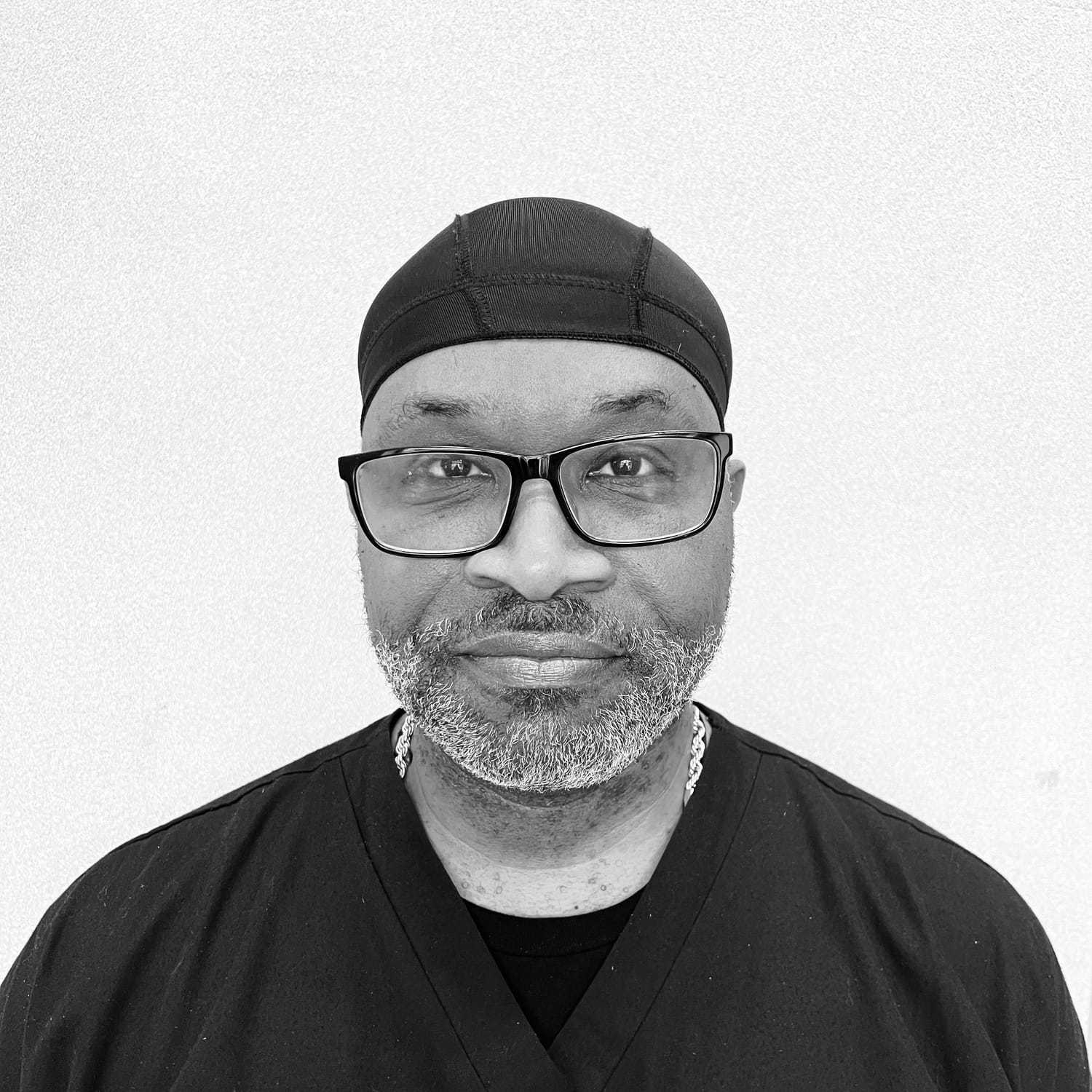 Portrait of Trevor, a professional stylist at The Robert Andrew Salon & Spa Collection, showcasing their expertise and style.