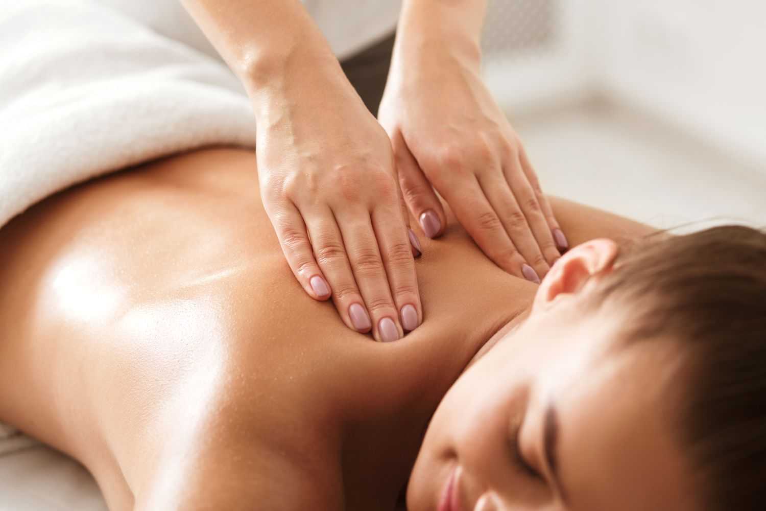 Person receiving a relaxing back massage in a wellness spa.