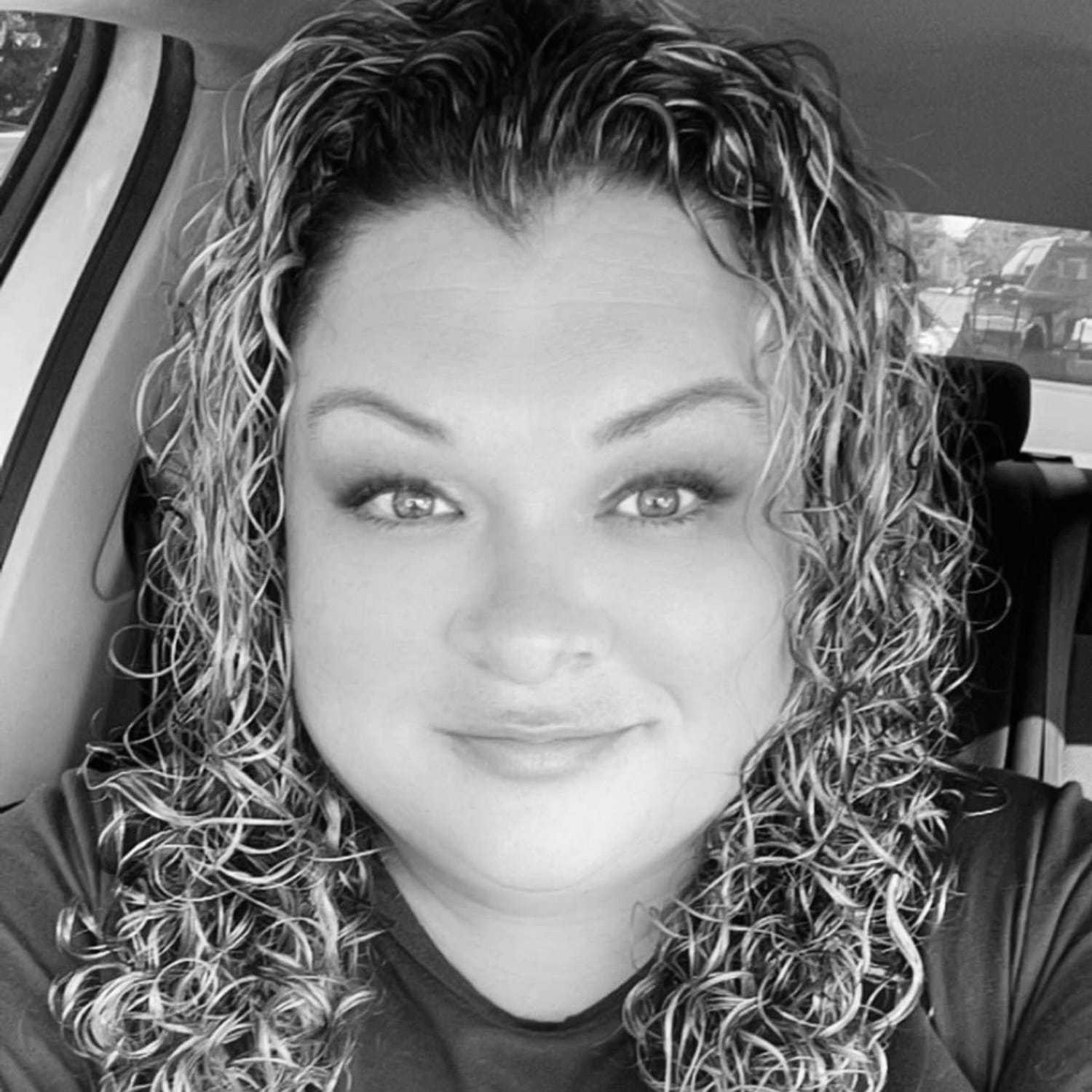 Portrait of Mia, a professional stylist at The Robert Andrew Salon & Spa Collection, showcasing their expertise and style.