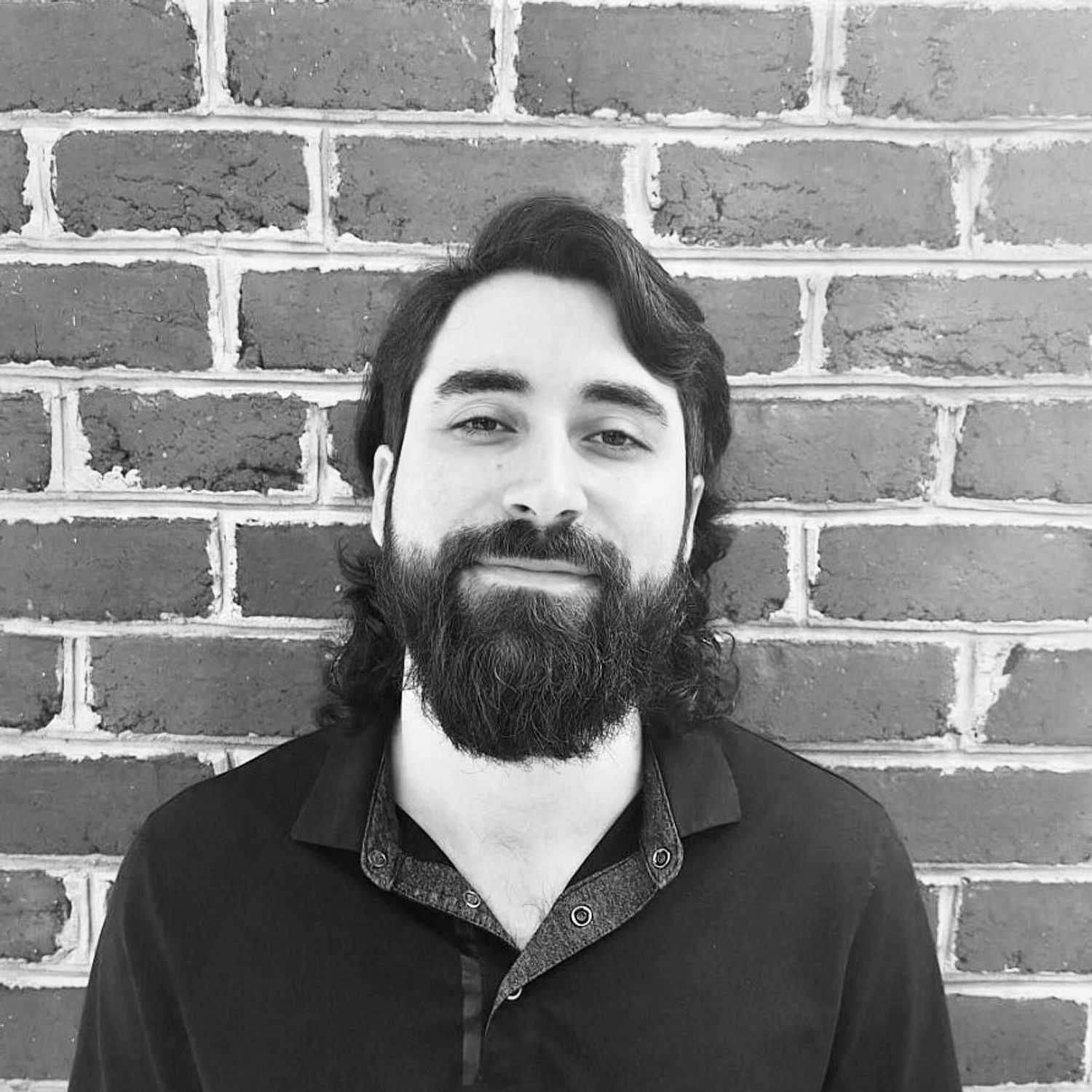 Portrait of Brandon, a professional stylist at The Robert Andrew Salon & Spa Collection, showcasing their expertise and style.