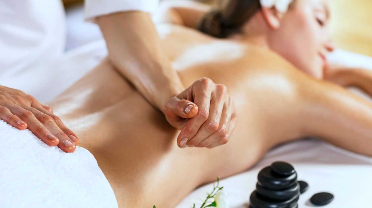 Woman receiving a back massage at a spa.