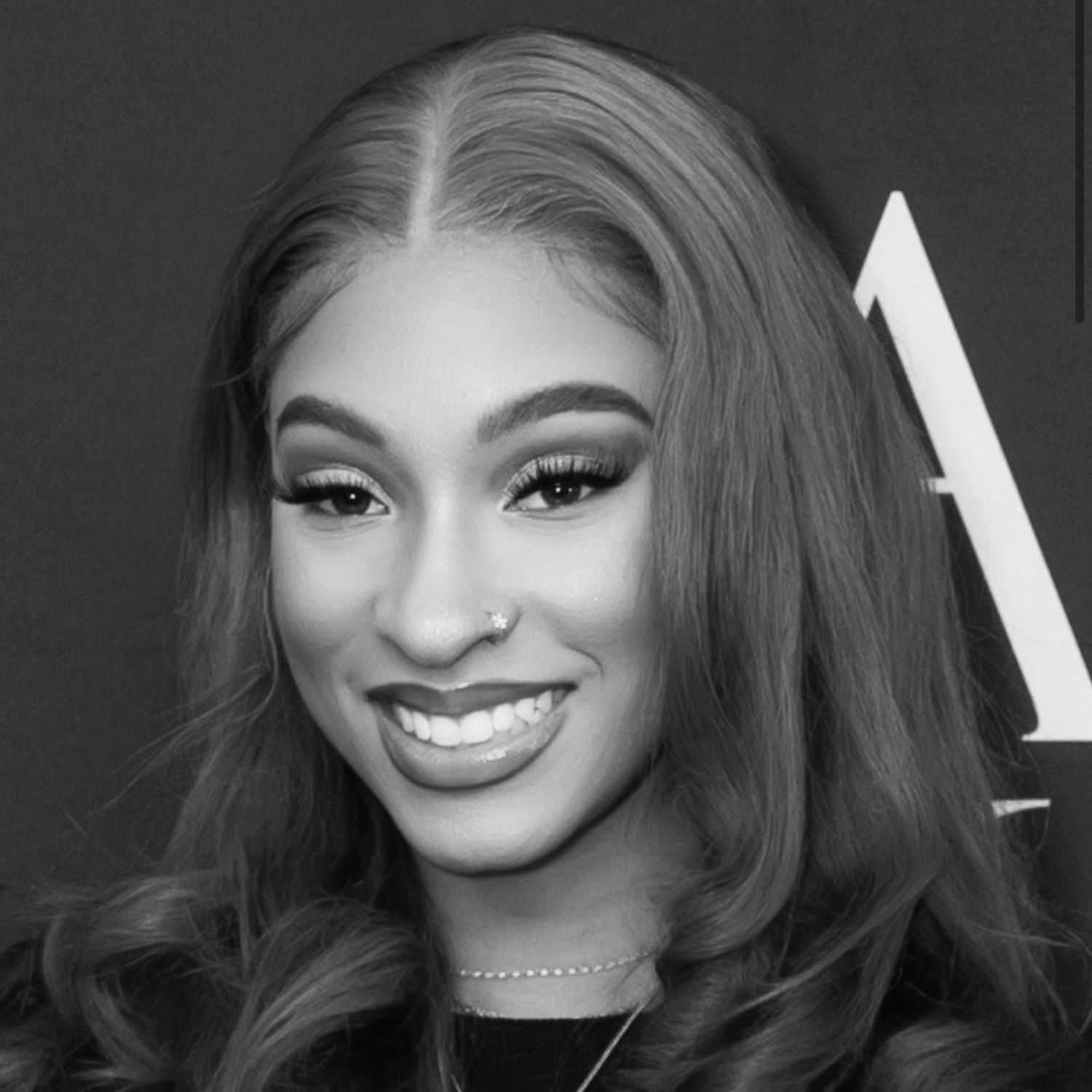 Portrait of Nyla, a professional stylist at The Robert Andrew Salon & Spa Collection, showcasing their expertise and style.