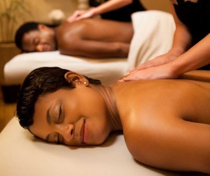 Couple enjoying a relaxing massage session in a spa setting.
