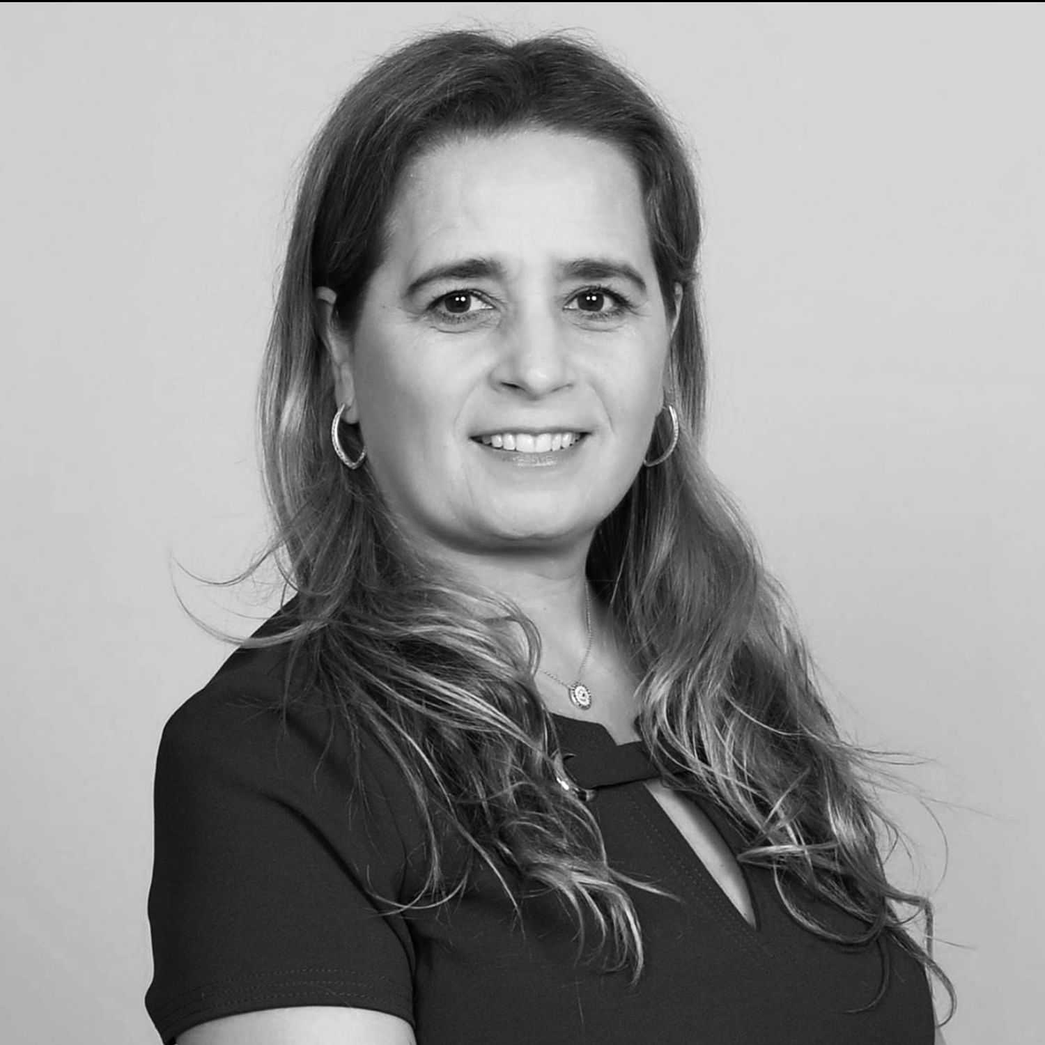 Portrait of Mirela, a professional stylist at The Robert Andrew Salon & Spa Collection, showcasing their expertise and style.