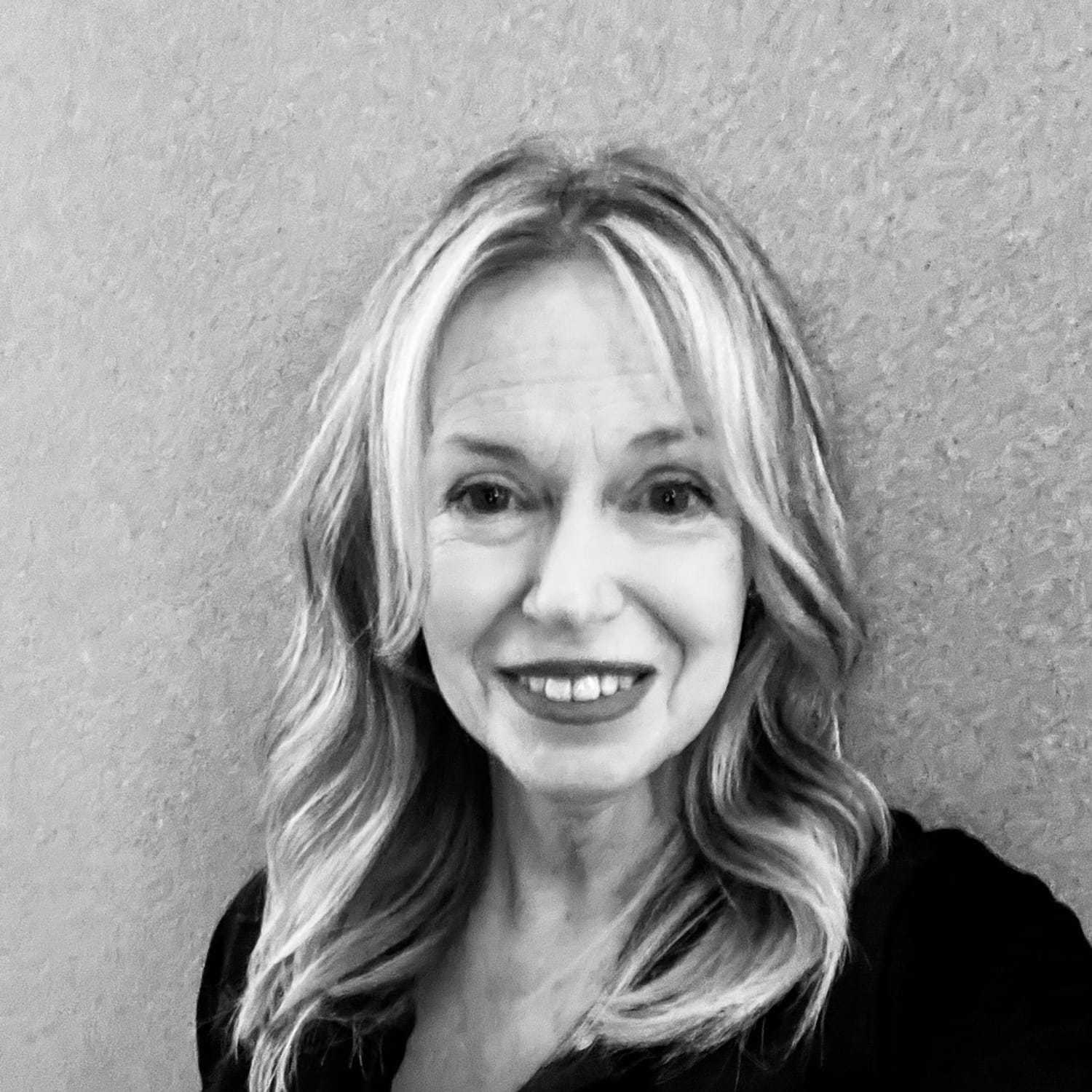 Portrait of Debbie, a professional stylist at The Robert Andrew Salon & Spa Collection, showcasing their expertise and style.