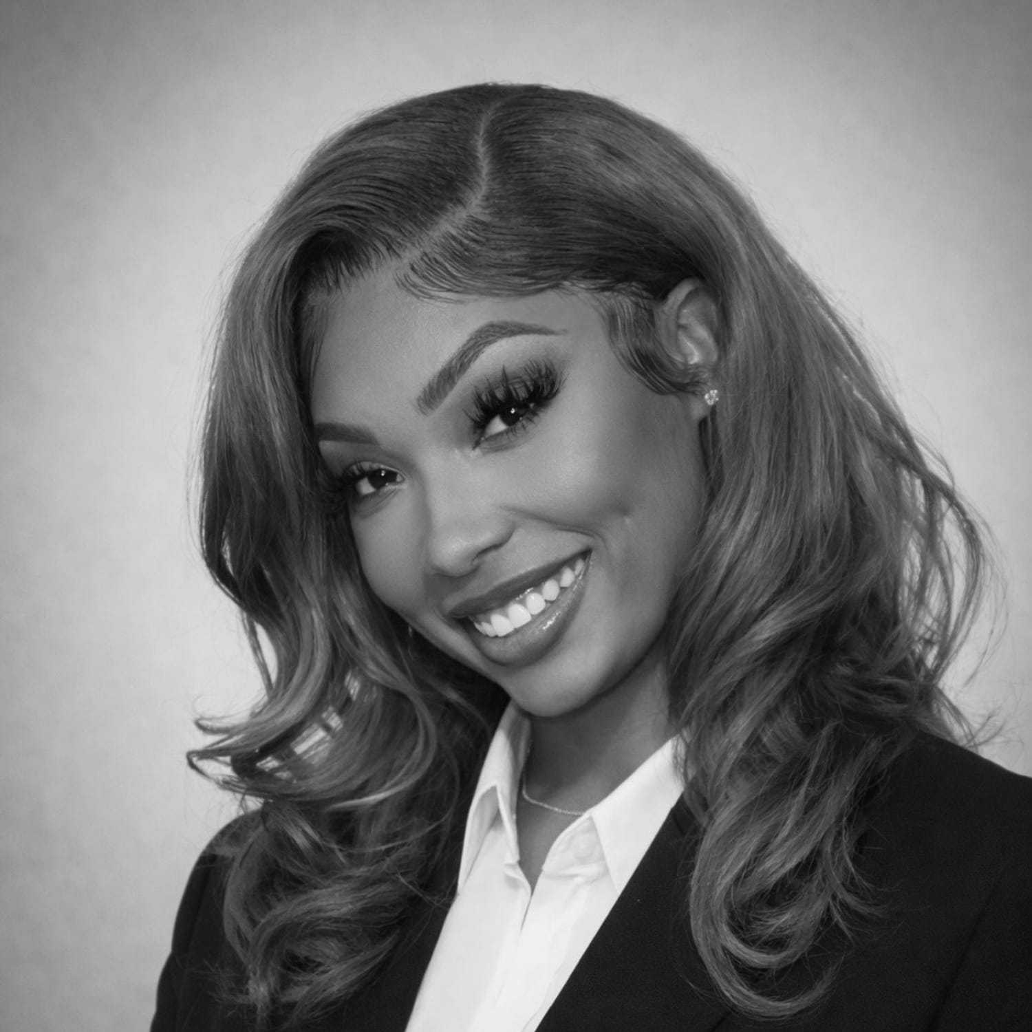 Portrait of Netta, a professional stylist at The Robert Andrew Salon & Spa Collection, showcasing their expertise and style.