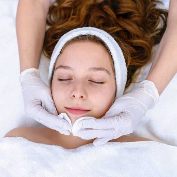 Woman receiving a facial treatment at a spa.