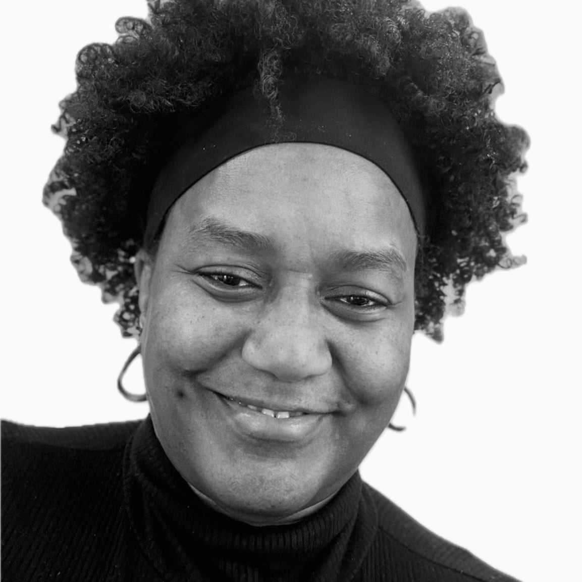 Portrait of Darlise, a professional stylist at The Robert Andrew Salon & Spa Collection, showcasing their expertise and style.
