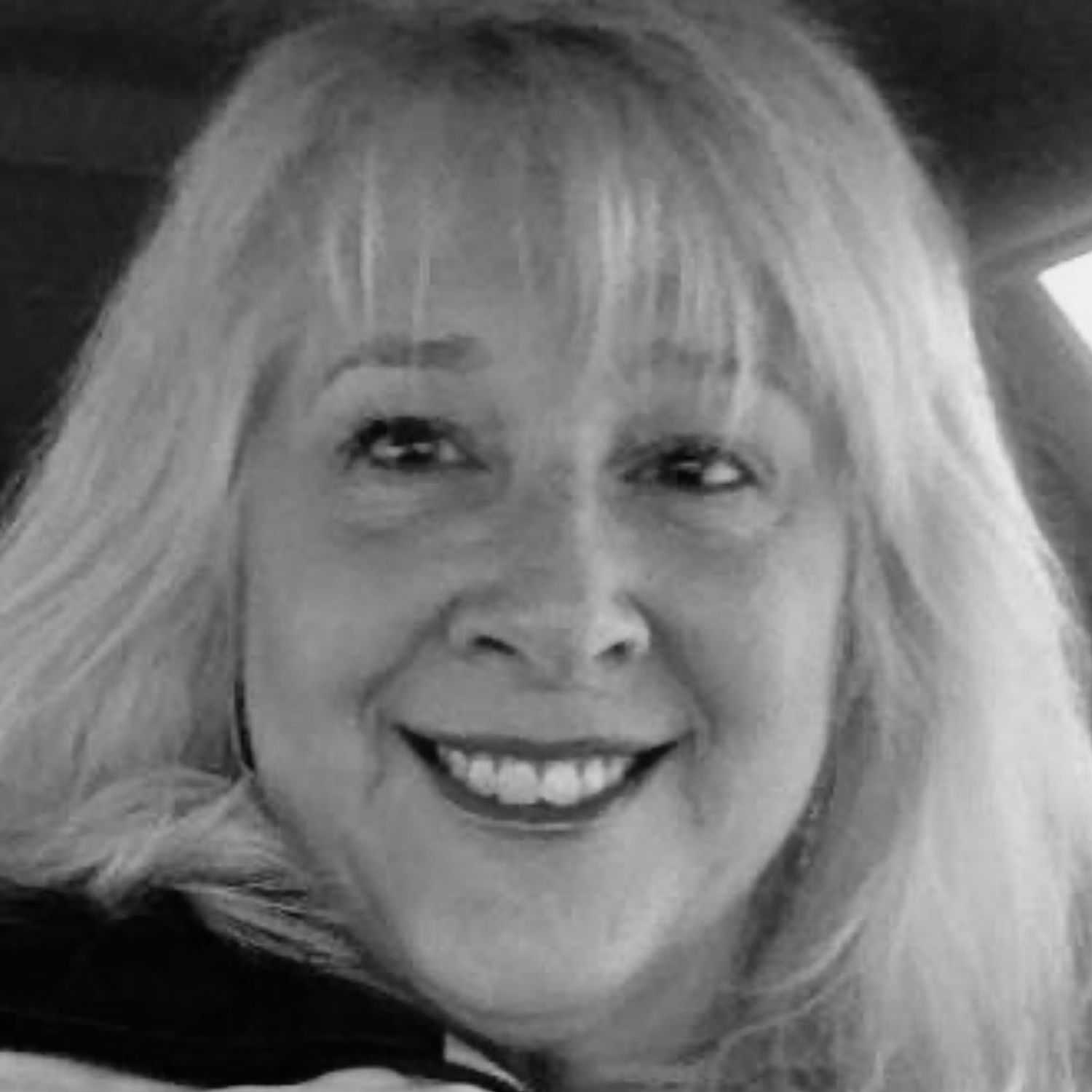 Portrait of Kim, a professional stylist at The Robert Andrew Salon & Spa Collection, showcasing their expertise and style.