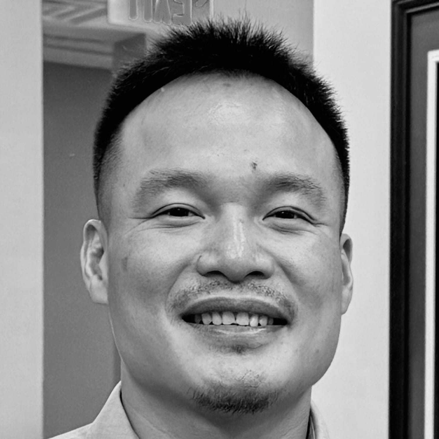 Portrait of Khoa, a professional stylist at The Robert Andrew Salon & Spa Collection, showcasing their expertise and style.