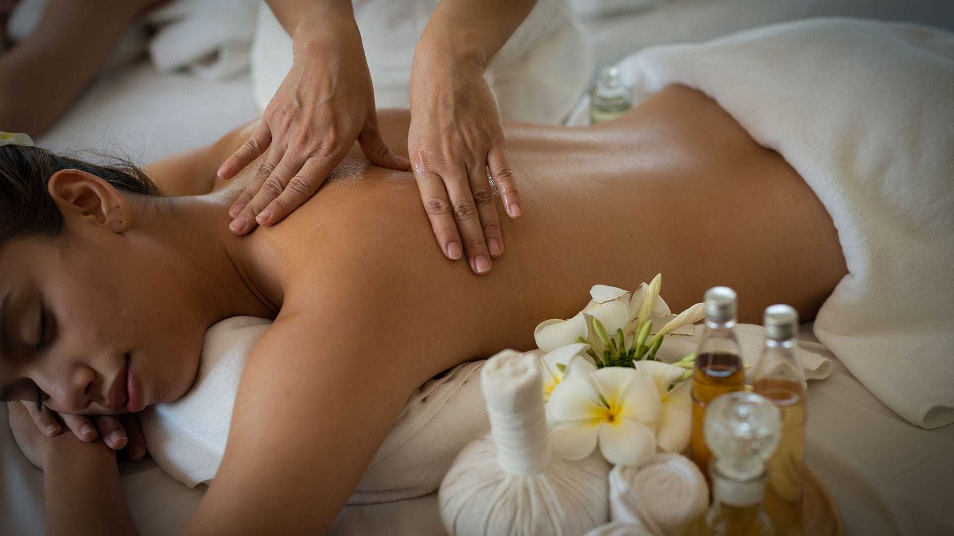 Woman receiving a relaxing back massage at a spa.