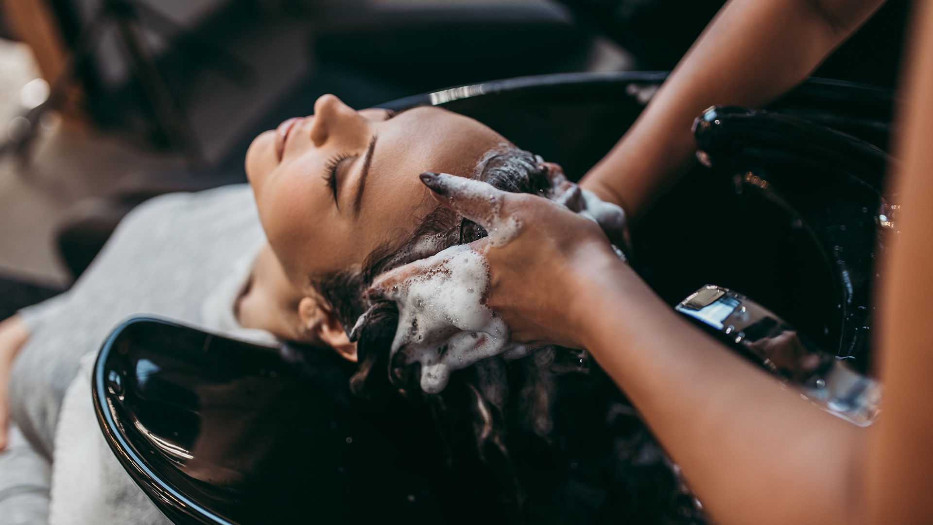 Woman getting her hair washed at a salon.
