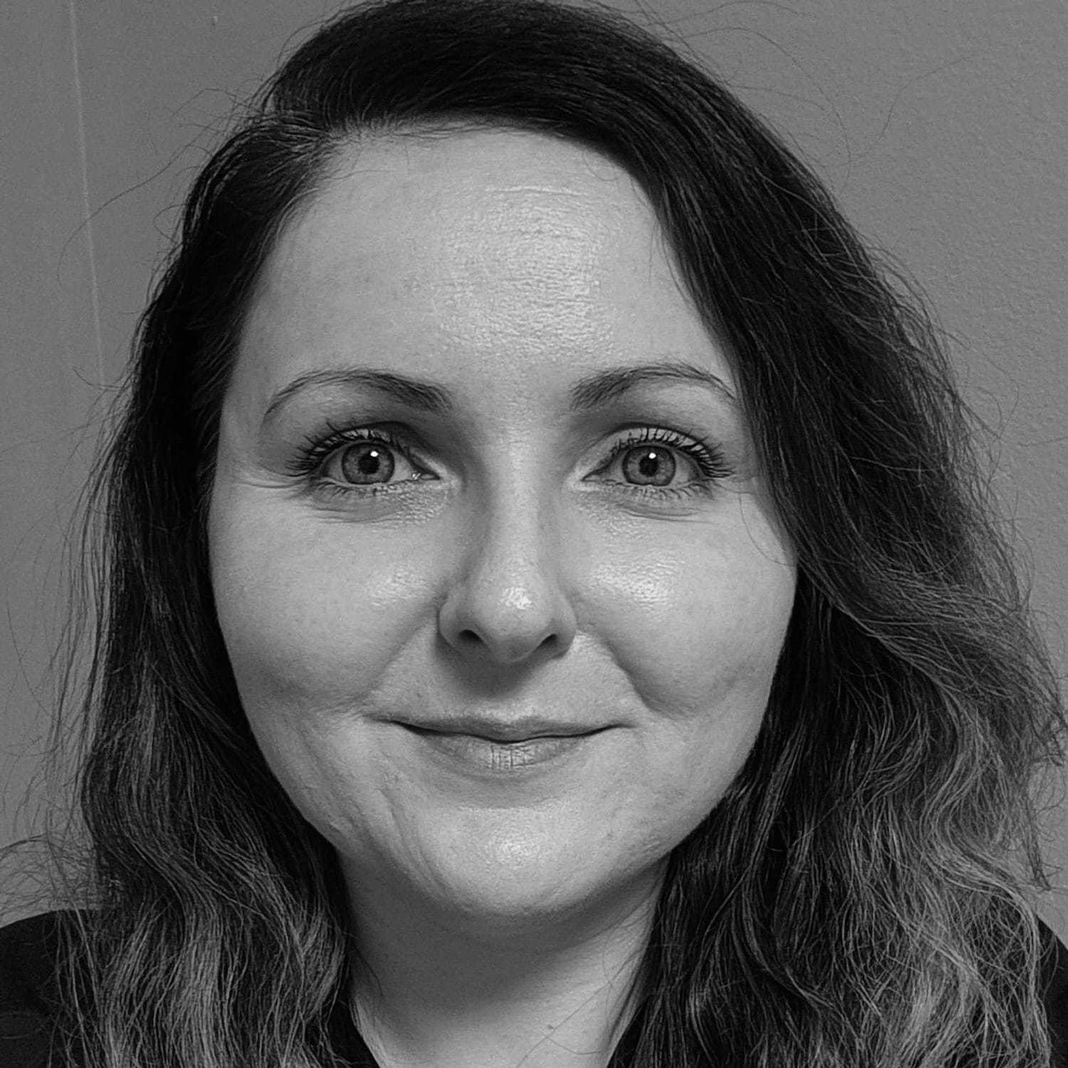 Portrait of Theresa, a professional stylist at The Robert Andrew Salon & Spa Collection, showcasing their expertise and style.