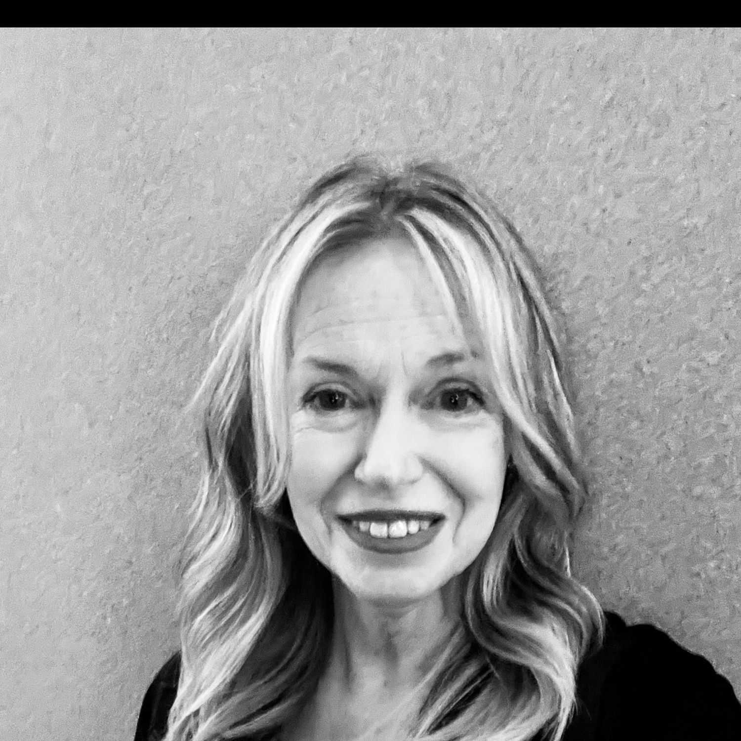 Portrait of Debbie, a professional stylist at The Robert Andrew Salon & Spa Collection, showcasing their expertise and style.