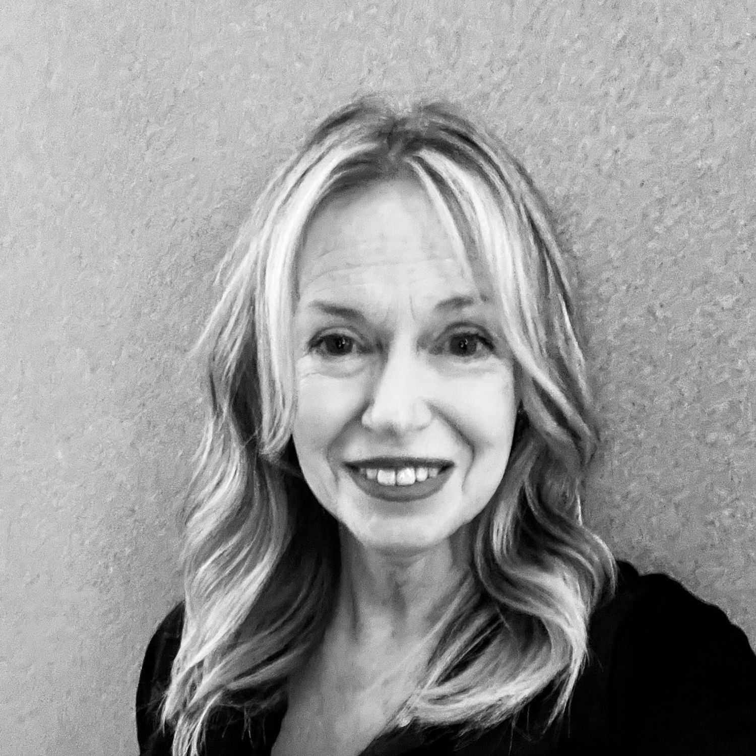 Portrait of Debbie, a professional stylist at The Robert Andrew Salon & Spa Collection, showcasing their expertise and style.