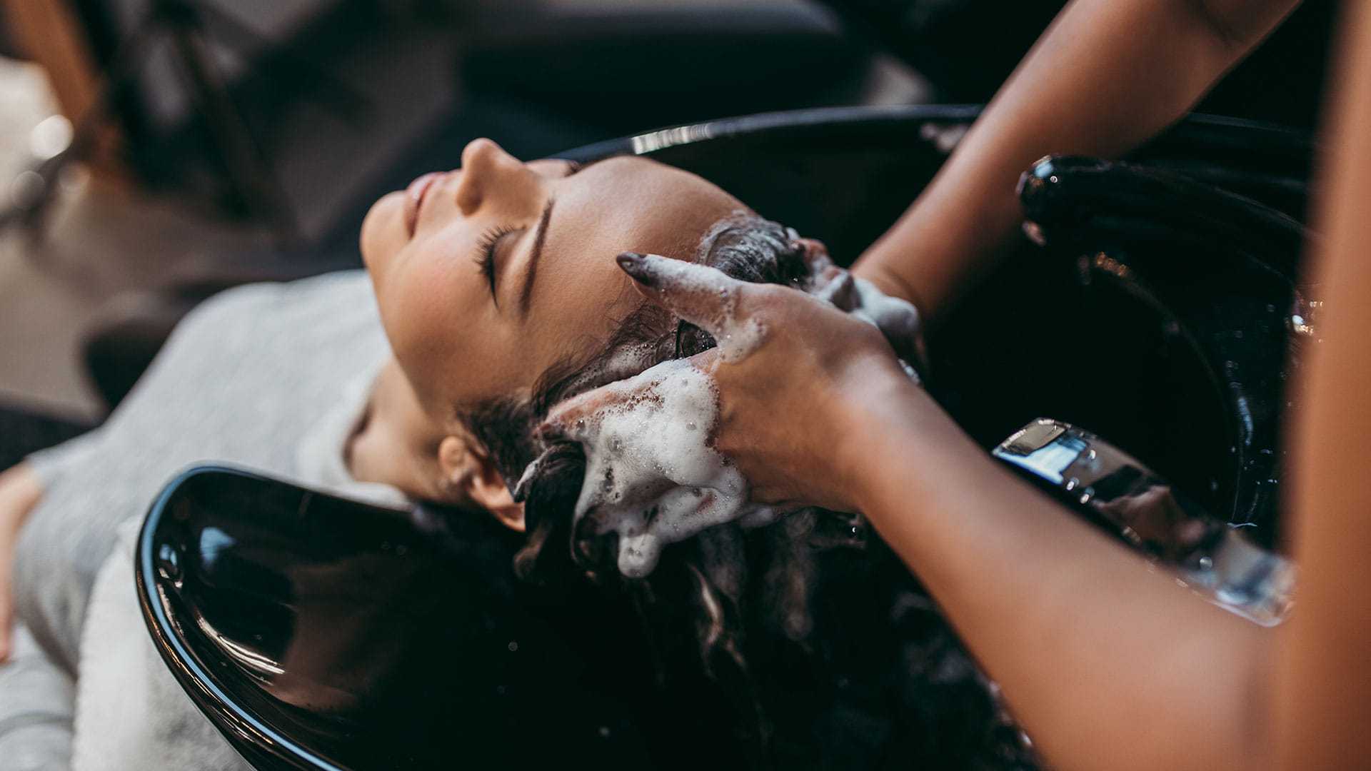 Woman getting her hair washed at a salon.