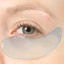Gel eye patch applied under an eye on smooth, fair skin for skincare treatment.