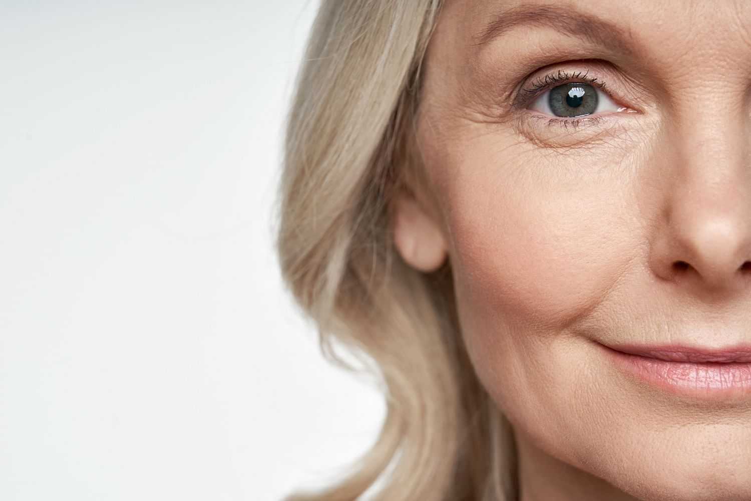 Close-up of mature woman's half-face with a focus on her eye.