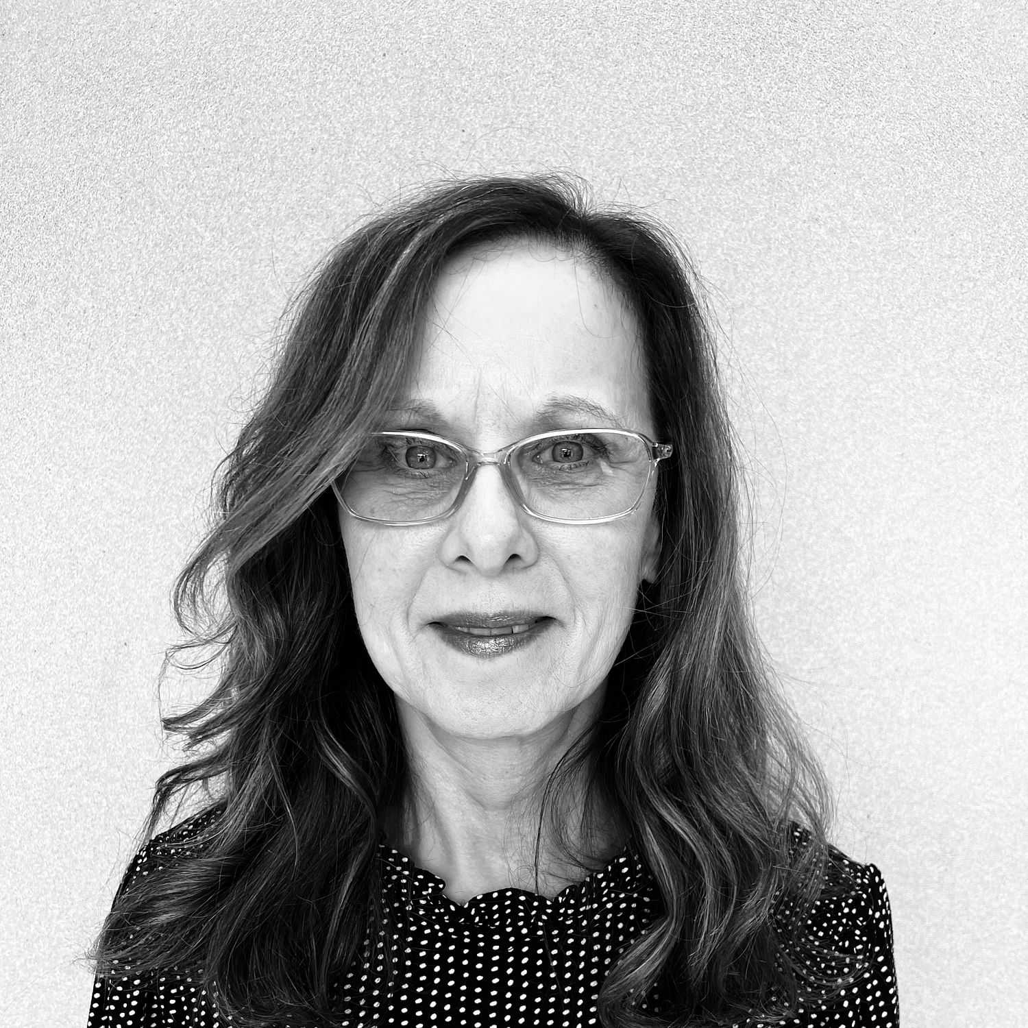 Portrait of Wilma, a professional stylist at The Robert Andrew Salon & Spa Collection, showcasing their expertise and style.