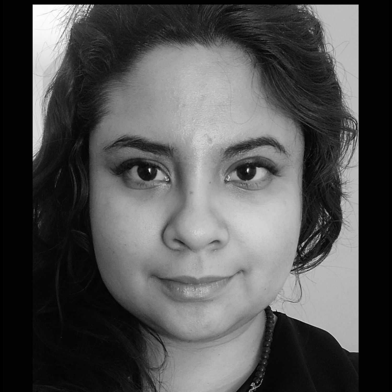 Portrait of Raquel, a professional stylist at The Robert Andrew Salon & Spa Collection, showcasing their expertise and style.